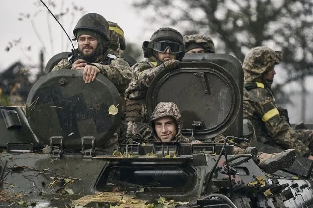 Ukrainian soldiers ride an APC in Donetsk region, Ukraine, Thursday, October 20, 2022. (Photo by LIBKOS/AP Photo)