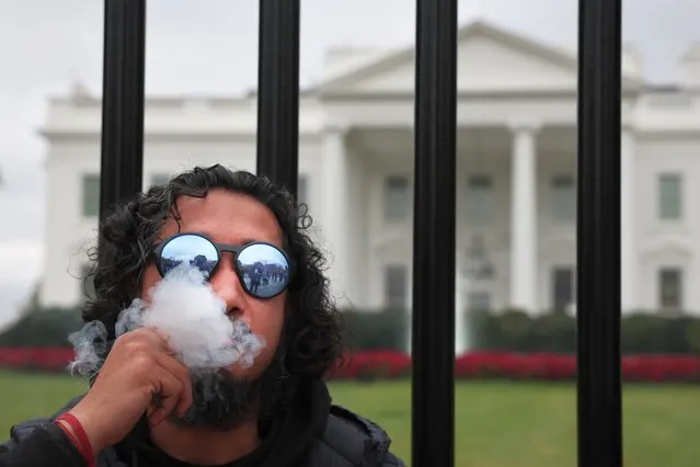 Hemant Shahi (C) smokes a joint while joining cannabis reform protesters outside the White House to call on U.S. President Joe Biden “to take action on cannabis clemency before the November general election” October 24, 2022 in Washington, DC. Various groups gathered to “demand clemency for all cannabis prisoners” and to assert that Biden's recent executive action on cannabis “failed to release a single inmate”. (Photo by Win McNamee/Getty Images)