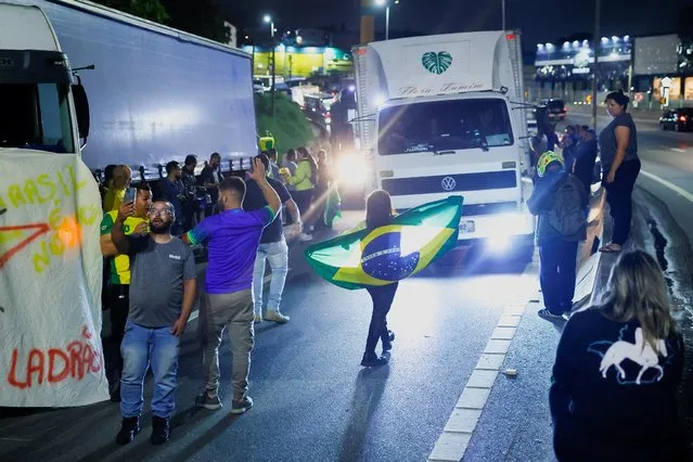 Supporters of Brazil's President Jair Bolsonaro react, during a protest over Bolsonaro's defeat in the presidential run-off election in Cotia, Brazil on October 31, 2022. (Photo by Amanda Perobelli/Reuters)