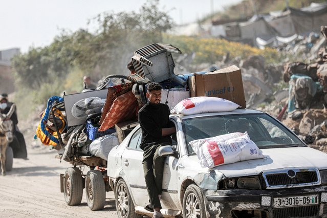 Palestinians make their way to flee their homes, after the Israel army issued evacuation orders for a number of neighborhoods, following heavy Israeli strikes, in Beit Lahiya in the northern Gaza Strip on March 18, 2025. (Photo by Abd Elhkeem Khaled/Reuters)