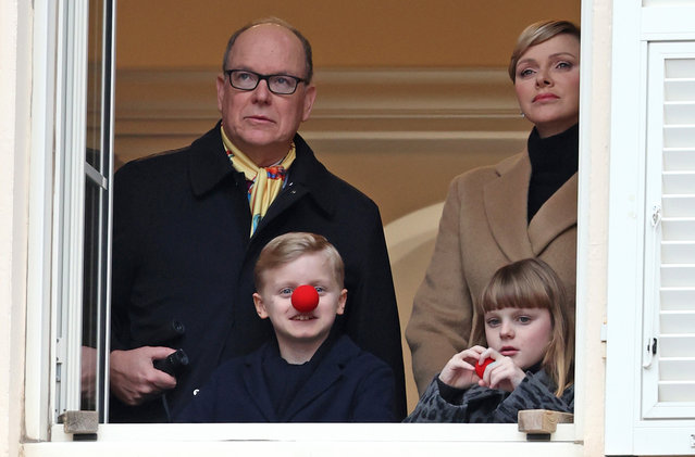(L-R) Albert II, Prince of Monaco, Prince Jacques of Monaco, Princess Gabriella of Monaco and Charlene, Princess of Monaco look out of a window during The Circus Parade on January 13, 2024 in Monaco, Monaco. (Photo by PLS Pool/Getty Images)