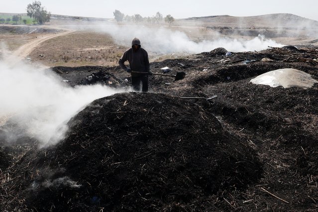 A worker produces charcoal, widely used for a grilling, as demand for it increases during the holy month of Ramadan in Mosul, Iraq, on March 15, 2025. (Photo by Khalid al-Mousily/Reuters)