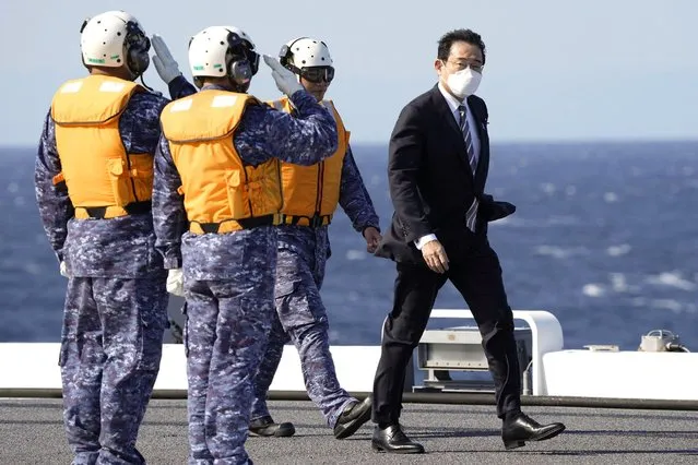 Japanese Prime Minister Fumio Kishida walks on the Maritime Self Defense Force's helicopter carrier JS Izumo during an international fleet review in Sagami Bay, southwest of Tokyo, Sunday, November 6, 2022. Kishida, at an international fleet review Sunday, said his country urgently needs to build up military capabilities as it faces worsening security environment in the East and South China Seas and threats from North Korea’s nuclear and missile advancement and Russia’s war on Ukraine.(Photo by Kyodo News via AP Photo)