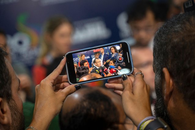 A journalist records a video of Norway's Foreign Affairs Minister Espen Barth Eide talking during a press conference at the G20 Foreign Ministers meeting in Rio de Janeiro, Brazil on February 21, 2024. Foreign ministers of the G20 group of nations open a two-day meeting Wednesday in Brazil, with a bleak outlook for progress on a thorny agenda of conflicts and crises, from the Gaza and Ukraine wars to growing polarization. (Photo by Mauro Pimentel/AFP Photo)