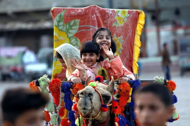Children react while riding on a camel at a playground in slum, as public places remain closed as preventive measures against the coronavirus disease (COVID-19) pandemic, during Eid al-Adha celebration, in Karachi, Pakistan on August 2, 2020. (Photo by Akhtar Soomro/Reuters)