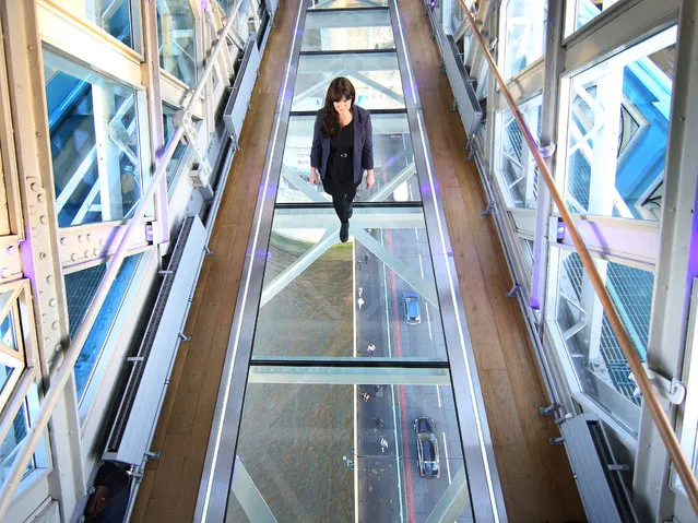 A visitor crosses Tower Bridge's new glass walkway on November 10, 2014 in London, England. (Photo by Peter Macdiarmid/Getty Images)