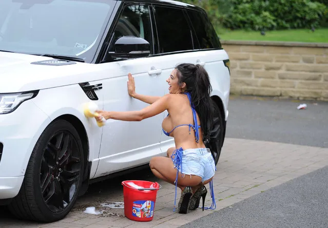UK Big Brother star Chloe Khan washes her Land Rover wearing a bikini and hot pants  in Borehamwood, England on September 22, 2016. (Photo by Palace Lee)