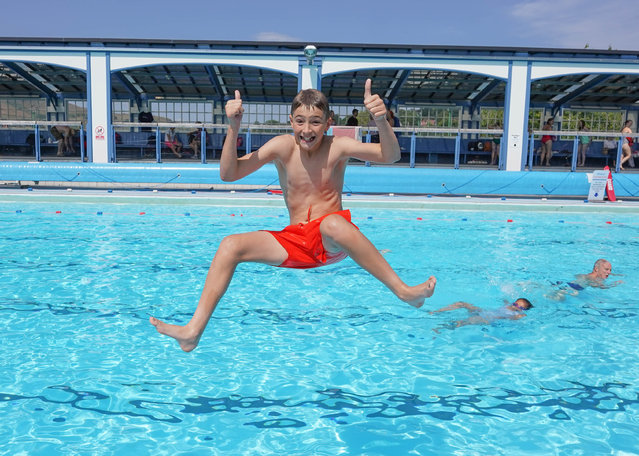 Josh Smith, 14, cools off by taking a plunge into Hathersage swimming pool in the Peak District, UK on July 13, 2025. (Photo by Ioannis Alexopoulos/London News Pictures)