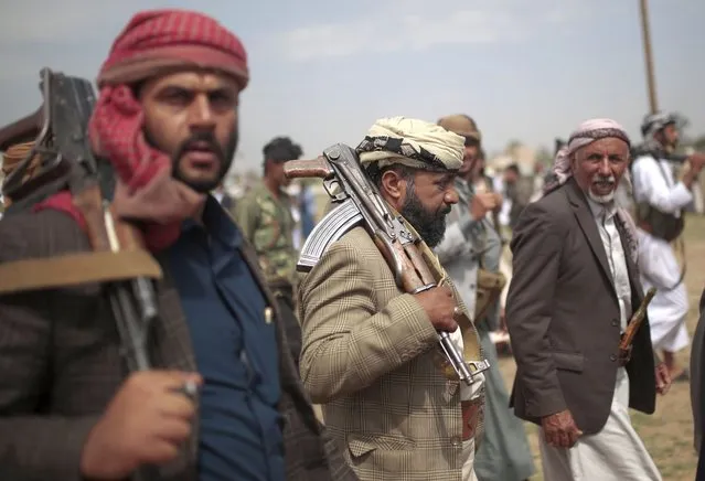 Tribesmen loyal to Houthi rebels hold their weapons as they attend a gathering against the agreement to establish diplomatic relations between Israel and the United Arab Emirates in Sanaa, Yemen, Saturday, August 22, 2020. (Photo by Hani Mohammed/AP Photo)