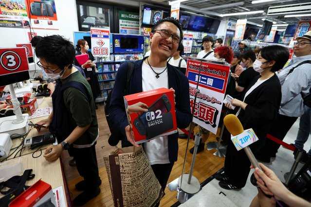 A customers holds his Nintendo Switch 2 game consoles as Nintendo starts selling the new consoles globally, at an electronics store in Tokyo, Japan on June 5, 2025. (Photo by Issei Kato/Reuters)