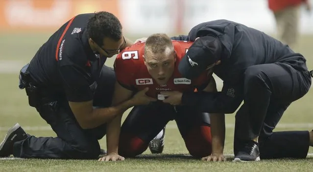 Calgary Stampeders' Rob Maver is treated after an injury in the second half against the Hamilton Tiger Cats during the CFL's 102nd Grey Cup football championship in Vancouver, British Columbia, November 30, 2014. (Photo by Todd Korol/Reuters)
