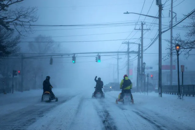 People ride snowmobiles on Rt. 112 as a blizzard hits the Northeastern part of the United States on January 4, 2018 in Medford, New York. From Maine to Florida every state along the east coast is expected to have to deal with winter weather. (Photo by Andrew Theodorakis/Getty Images)