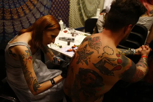 A man is tattooed by an artist during the Warsaw Tattoo Convention 2014 in Warsaw November 29, 2014. (Photo by Kacper Pempel/Reuters)