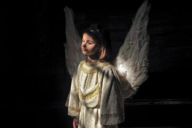 Celia de La Vega, 7, dressed as an angel,  during the Easter Sunday ceremony “Descent of the Angel”', during Holy Week in the small town of Tudela, northern Spain, Sunday, March 31, 2013. (Photo by Alvaro Barrientos/AP Photo)