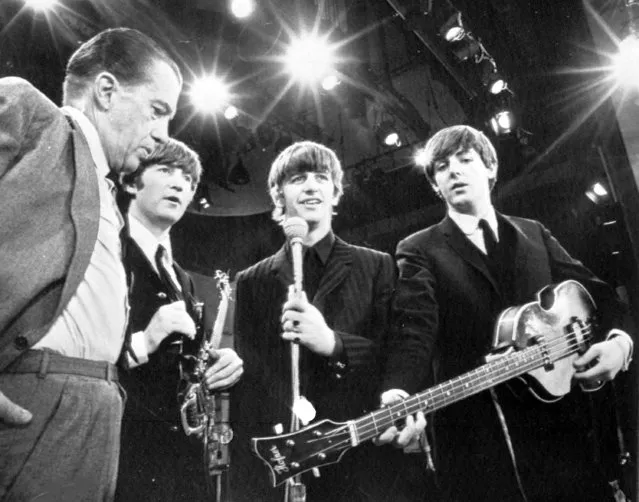 American TV host Ed Sullivan, left, talks with three members of the British pop group The Beatles during a rehearsal for their appearance on his TV show, in New York, February 8, 1964. From left, Sullivan, John Lennon, Ringo Starr and Paul McCartney. George Harrison, the fourth member of the group missed the rehearsal due to illness. (Photo by AP Photo)