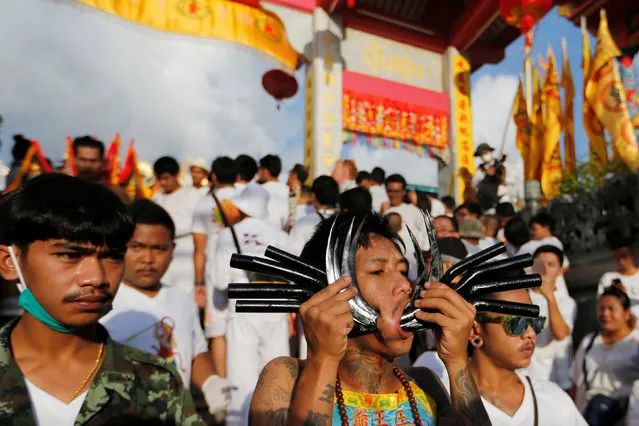A devotee of the Chinese Jui Tui shrine takes part in a procession celebrating the annual vegetarian festival in Phuket, Thailand, October 7, 2016. (Photo by Jorge Silva/Reuters)