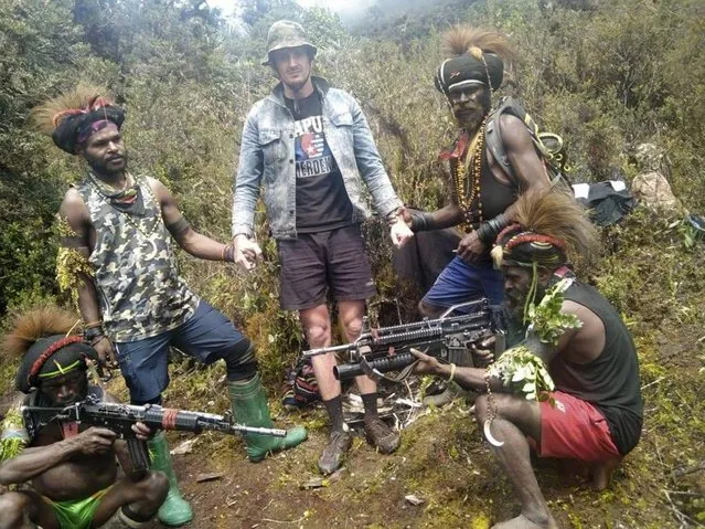 In this undated photo released by West Papua Liberation Army, the armed wing of the Free Papua Movement, Papuan separatist rebels pose for a photo with a man they said is New Zealander pilot Phillip Mark Mehrtens who they took hostage last week, at an undisclosed location in Papua province, Indonesia. Mehrtens, a pilot for Indonesian aviation company Susi Air, was abducted by the independence fighters who stormed his single-engine plane shortly after it landed on a small runway in Paro in remote Nduga district. (Photo by West Papua Liberation Army via AP Photo)