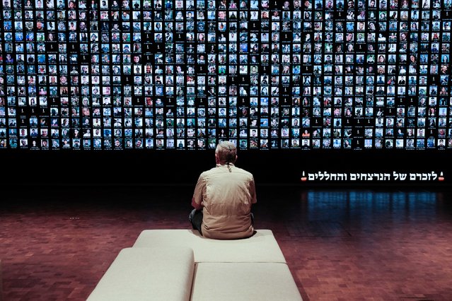 Visitors pay tribute to Israel's fallen servicemen and victims of terror on Memorial Day, Yom Hazikaron, as they stand before a large screen displaying the portraits of over 1,500 Israelis slain in the October 7th, 2023, Hamas massacre in southern Israel, along with those who sacrificed their lives in the ongoing conflicts in Gaza, at the National Library in Jerusalem on May 13, 2024. (Photo by Nir Alon/ZUMA Press Wire/EPA/EFE/Rex Features/Shutterstock)