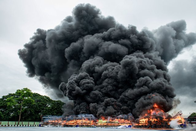 Smoke rises during a destruction ceremony of seized illegal drugs to mark the UN's “International Day against Drug Abuse and Illicit Trafficking” in Yangon on June 26, 2025. (Photo by Sai Aung Main/AFP Photo)