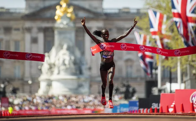 Vivian Cheruiyot of Kenya celebrates after crossing the finish line to win the elite women's race during the Virgin Money London Marathon at United Kingdom on April 22, 2018 in London, England. (Photo by Justin Setterfield/Getty Images)