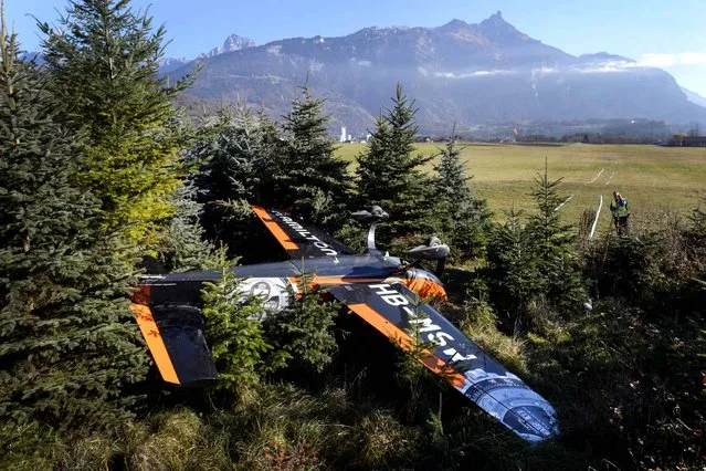 An aerobatic airplane which crashed during landing on November 18, 2015 is seen at the airdrome in Bex, western Switzerland. Two person were injured during the accident. (Photo by Fabrice Coffrini/AFP Photo)