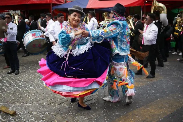 A couple of dancers participate in the burial of Pepino during the closing acts of the carnival in La Paz, Bolivia on February 26, 2023. In the Andean region of Bolivia, carnival activities come to an end with the burial of Pepino, a typical and main character of the carnival, where hundreds of people, including women, children and others, simulate a procession that is in charge of carrying the Pepino to its coffin. After that, hundreds of dancers known as Chutas dance in the company of women dressed as Chola and Pepinos in the surroundings of the general cemetery and in this way the carnival ends until the following year. (Photo by Luis Gandarillas/Anadolu Agency via Getty Images)