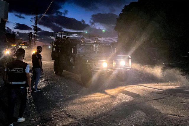 A Lebanese army vehicle moves at the Ain al-Hilweh camp for Palestinian refugees in Lebanon's southern city of Sidon on September 13, 2025, as armed Palestinian groups hand over their weapons to Lebanese authorities. Palestinian factions handed over weapons from Lebanon's largest refugee camp on September 13, an official from the Palestine Liberation Organisation (PLO) said, as part of a push by the government to disarm non-state groups. (Photo by Mahmoud Zayyat/AFP Photo)