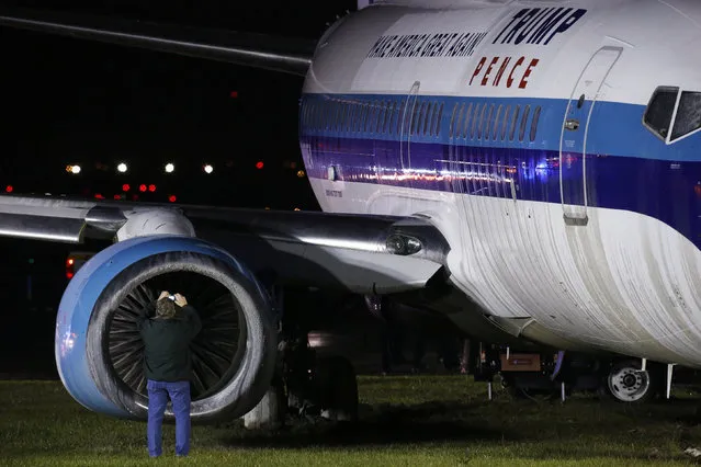 A man takes a photographs as he inspects a campaign plane that had been carrying U.S. Republican vice presidential nominee Mike Pence after it skidded off the runway while landing in the rain at LaGuardia Airport in New York, U.S.,October 27, 2016. (Photo by Lucas Jackson/Reuters)