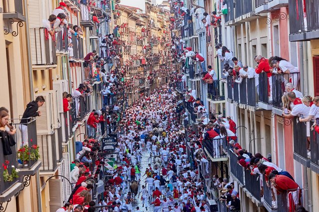 People take part in the traditional “encierro” (bull-run) of the San Fermin Festival in Pamplona, Spain on July 07, 2024. The bull-running fiesta is held annually from 06 to 14 July in commemoration of the city's patron saint. Visitors from all over the world attend the festival. Many of them physically participate in the highlight event – the running of the bulls, or encierro – where they attempt to outrun the animals along a route through the narrow streets of Pamplona's old city. (Photo by Ruben Albarran/Rex Features/Shutterstock)