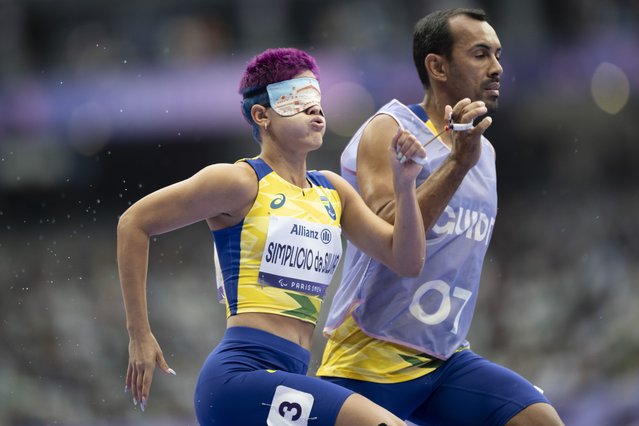 Thalita Vitoria Simplicio da Silva and her guide Felipe Veloso da Silva of Brazil compete during the Women's 400m T11 Qualification of the Para Athletics competitions in the Paris 2024 Paralympic Games, in Paris, France, 30 August 2024. (Photo by Ennio Leanza/EPA/EFE)