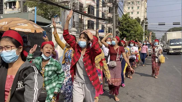 In this image made from video, protesters flash the three-fingered salute while they march Saturday, February 6, 2021, in Yangon, Myanmar. The military authorities in charge of Myanmar broadened a ban on social media following this week’s coup, shutting access to Twitter and Instagram, while street protests continued to expand Saturday as people gathered again to show their opposition to the army takeover. (Photo by AP Photo/Stringer)
