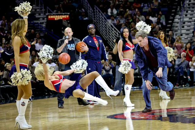 Will Ferrell hits an actress playing a member of the New Orleans Pelicans dance team with a ball during a stunt filmed for the movie “Daddy's Home” at halftime of a game against the Los Angeles Lakers in New Orleans, January 21, 2015. (Photo by Derick E. Hingle/USA TODAY Sports)