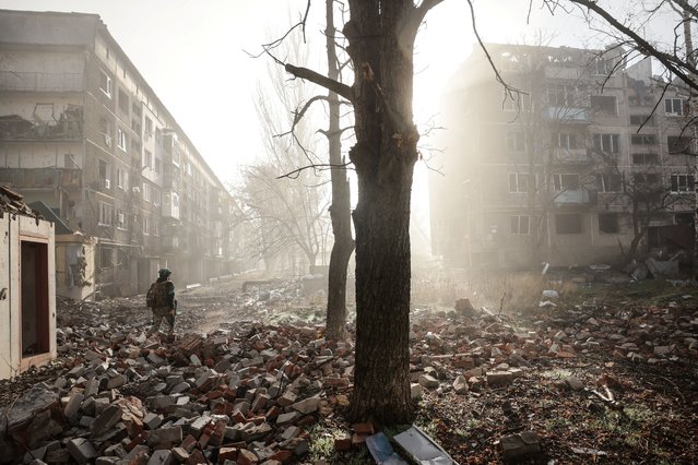 In this handout photograph taken by the press service of the 24th Mechanized Brigade of Ukrainian Armed Forces on November 15, 2025 and released on November 17, 2025, a Ukrainian serviceman stands among the rubble in the courtyard of a destroyed residential building in the frontline town of Kostyantynivka, Donetsk region, amid the Russian invasion of Ukraine. (Photo by Oleg Petrasiuk/24th Mechanized Brigade of Ukrainian Armed Forces/AFP Photo)