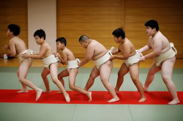 Kyuta Kumagai, 10, warms up with other boys before training, at Komatsuryu sumo club in Tokyo, Japan, August 23, 2020. “It is fun to beat people older than me”, said Kyuta. (Photo by Kim Kyung-Hoon/Reuters)