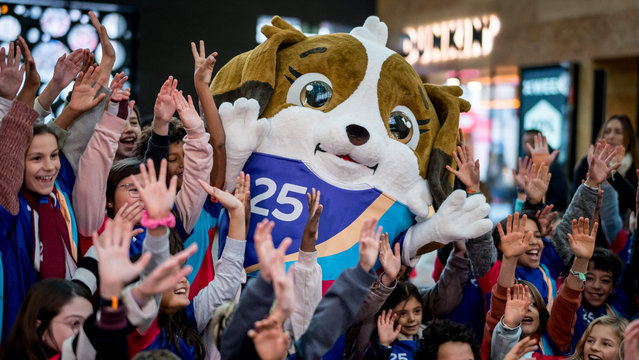 Children gather around Maddli, the mascot of the upcoming UEFA Women's EURO 2025 football tournament during its official unveiling at Geneva train station on November 29, 2024. Sixteen national football teams will play a total of 31 matches in eight host cities across Switzerland over a four-week period from July 2 to July 27, 2025. (Photo by Fabrice Coffrini/AFP Photo)