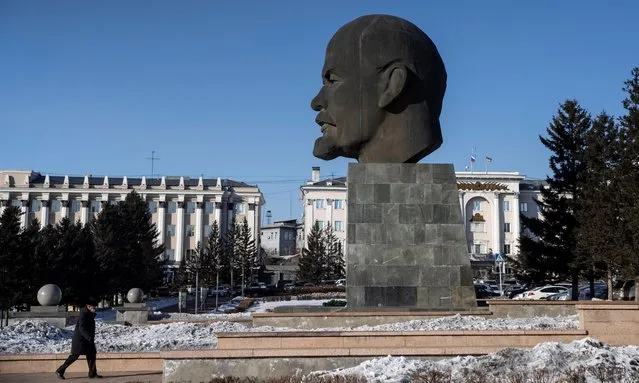 A man walks by a monument to the founder of the Soviet state Vladimir Lenin, also known as “the biggest head of Lenin in the World”, in Ulan-Ude, Republic of Buryatia, Russia on March 4, 2021. (Photo by Maxim Shemetov/Reuters)