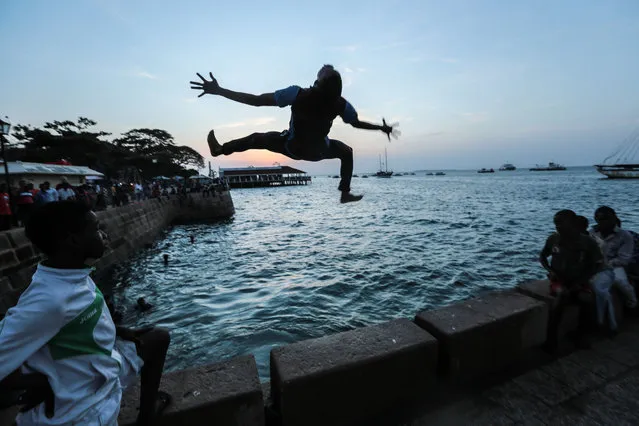 Zanzibari youth jump into the Indian Ocean from Forodhani Gardens park in the historical city of Stone Town, Zanzibar, Tanzania, on Wednesday, January 21, 2015. (Photo by Mosa'ab Elshamy/AP Photo)