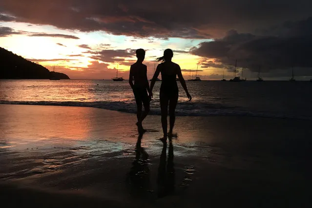 Youths play along the water on the beach of Rodney Bay after sunset in Gros Islet, St. Lucia, November 23, 2016. (Photo by Carlo Allegri/Reuters)