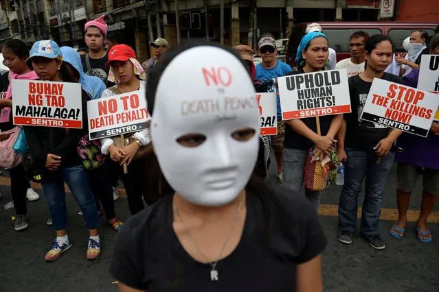 Activists hold placards as they protest against what they say are drug-related extrajudicial killings, during the International Human Rights Day in Manila, Philippines December 10, 2016. The protesters are calling on the Government for an end to extra-judicial killings in the country which already claimed the lives of more than 4,000 people. (Photo by Ezra Acayan/Reuters)