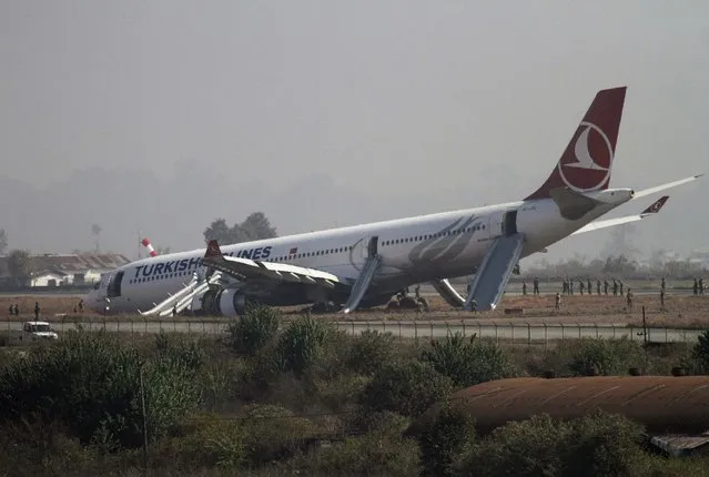 A Turkish Airlines plane lies on the field after it overshot the runway at Tribhuvan International Airport in Kathmandu March 4, 2015. According to local media  all passengers were rescued.  REUTERS/Navesh Chitrakar     