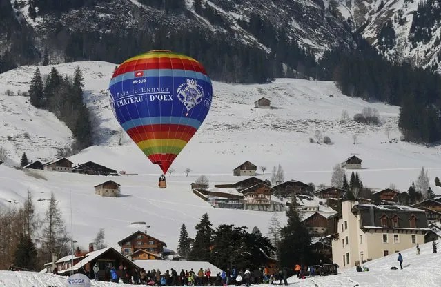 A balloon flies during the 38th International Hot Air Balloon Week in Chateau-d'Oex, Switzerland January 23, 2016. For nine days balloonists from 15 countries take part in the ballooning event in the Swiss mountain resort famous for ideal flight conditions due to an exceptional microclimate. (Photo by Denis Balibouse/Reuters)