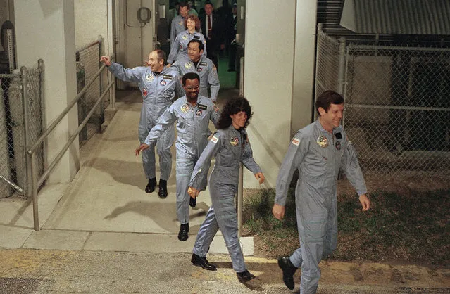 The crew for the Space Shuttle Challenger Flight 51-L, leaves their quarters for the launch pad, January 27, 1986 in Kennedy Space Center, Florida.  Front to back the commander Francis Scobee, Mission Spl. Judy Resnick, Mission Spl. Ronald McNair, Payload Spl. Gregory Jarvis, Mission Spl. Ellison Onizuka, teacher Christa McAuliffe and pilot Michael Smith. (Photo by Steve Helber/AP Photo)