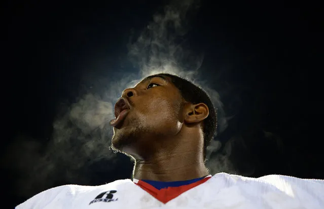 A player for the Fort Dorchester High School Football team yells to motivate players in a hostile regional game against Bluffton High School at Bluffton High School Stadium, October 24, 2014. The Patriots won the game and are now first in their region and second in the state of South Carolina. (Photo by Senior Airman Daniel Hughes/U.S. Air Force)