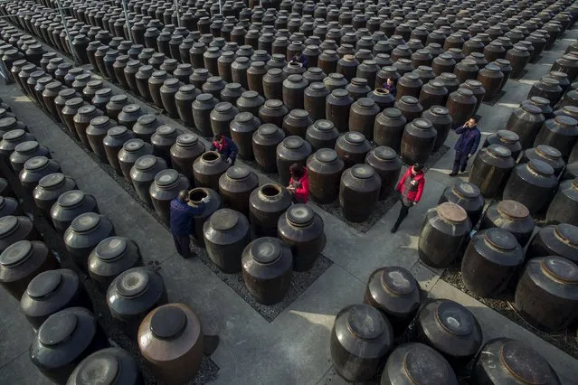Employees work at a vinegar and soy sauce mill in Zhenjiang, Jiangsu province, January 26, 2016. (Photo by Reuters/China Daily)
