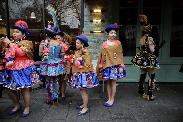 Dancers from Bolivia prepare in a side street before they perform in New Year's Day Parade in London, Britain January 1, 2017. (Photo by Kevin Coombs/Reuters)