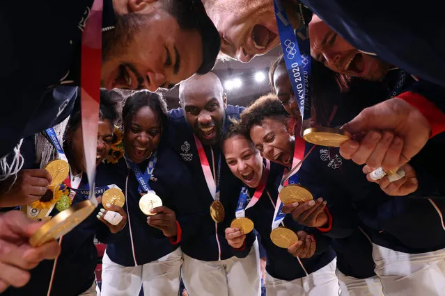 Team France celebrates with the gold medal during the podium ceremony for the judo mixed team of the Tokyo 2020 Olympic Games at the Nippon Budokan in Tokyo on July 31, 2021. (Photo by Jack Guez/AFP Photo)