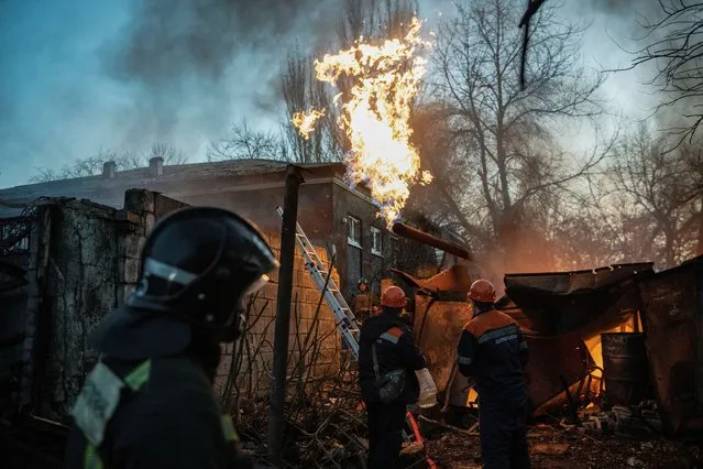 Rescuers work to put out fire outside a damaged residential building hit by recent shelling in the course of Russia-Ukraine conflict in Donetsk, Russian-controlled Ukraine on November 7, 2023. (Photo by Reuters/Stringer)