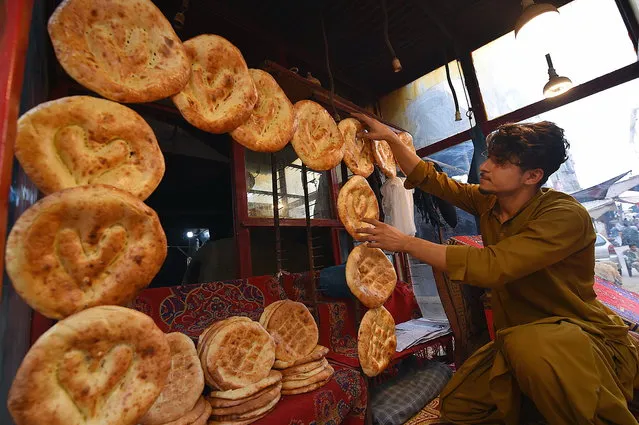 4 A man puts up traditional Afghani Naan for sale in Karachi, Pakistan, 20 November 2023. The sales of Afghani naan have significantly dropped in the neighborhoods after the Pakistani government's deadline to expel undocumented Afghan immigrants expired on 01 November 2023 and thousands of refugees returned to their homeland in neighboring Afghanistan. Afghani Naan, a traditional flatbread baked in Afghanistan, is considered the country's national bread and a daily staple in Afghan households. It is best enjoyed fresh from the oven and is served alongside almost every meal in Afghan cuisine. (Photo by Shahzaib Akber/EPA/EFE)