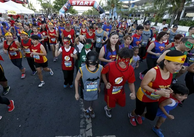 Runners wearing super heroes costumes take part in a DC Comics fun run in Manila April 18, 2015. (Photo by Romeo Ranoco/Reuters)