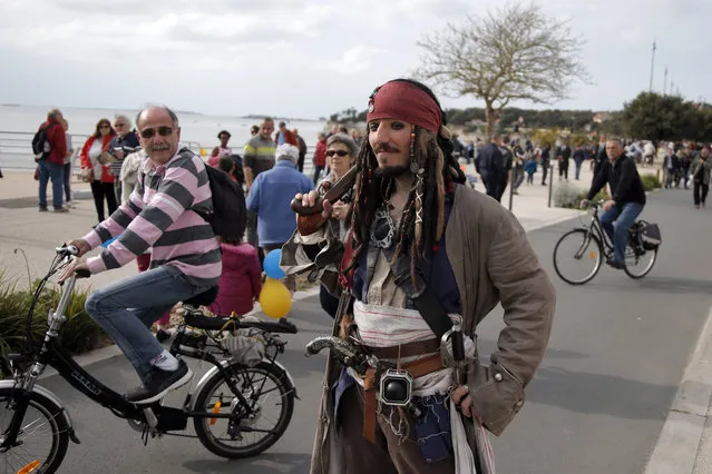Julien Godard, dressed as Captain Sparrow, right, poses for souvenir picture prior to the departure of the replica of the frigate Hermione, used to bring French troops and funds to American revolutionaries in 1780, in Fouras, southwest France, on his way for its transatlantic voyage, Saturday, April 18, 2015. (Photo by Francois Mori/AP Photo)